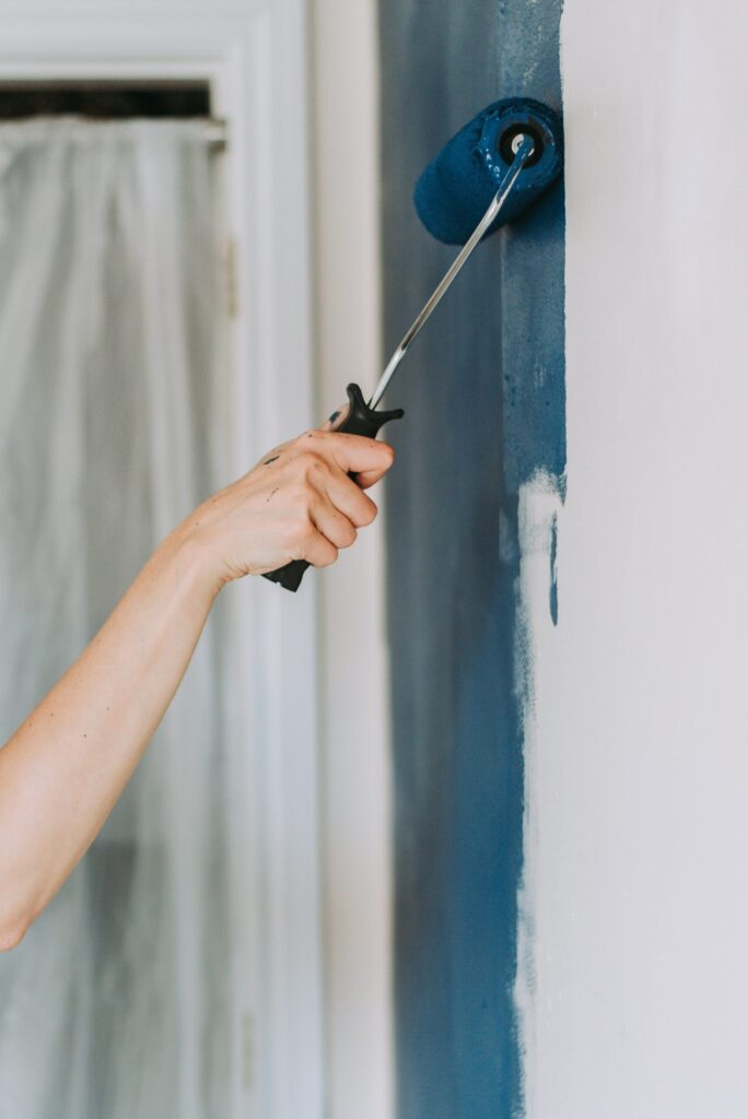 closeup shot person using paint rollers with color blue 1 scaled.jpg